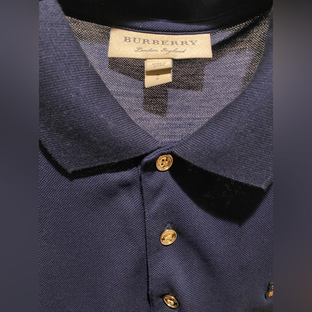Burberry Polo in navy blue with high quality metallic gold buttons and logo